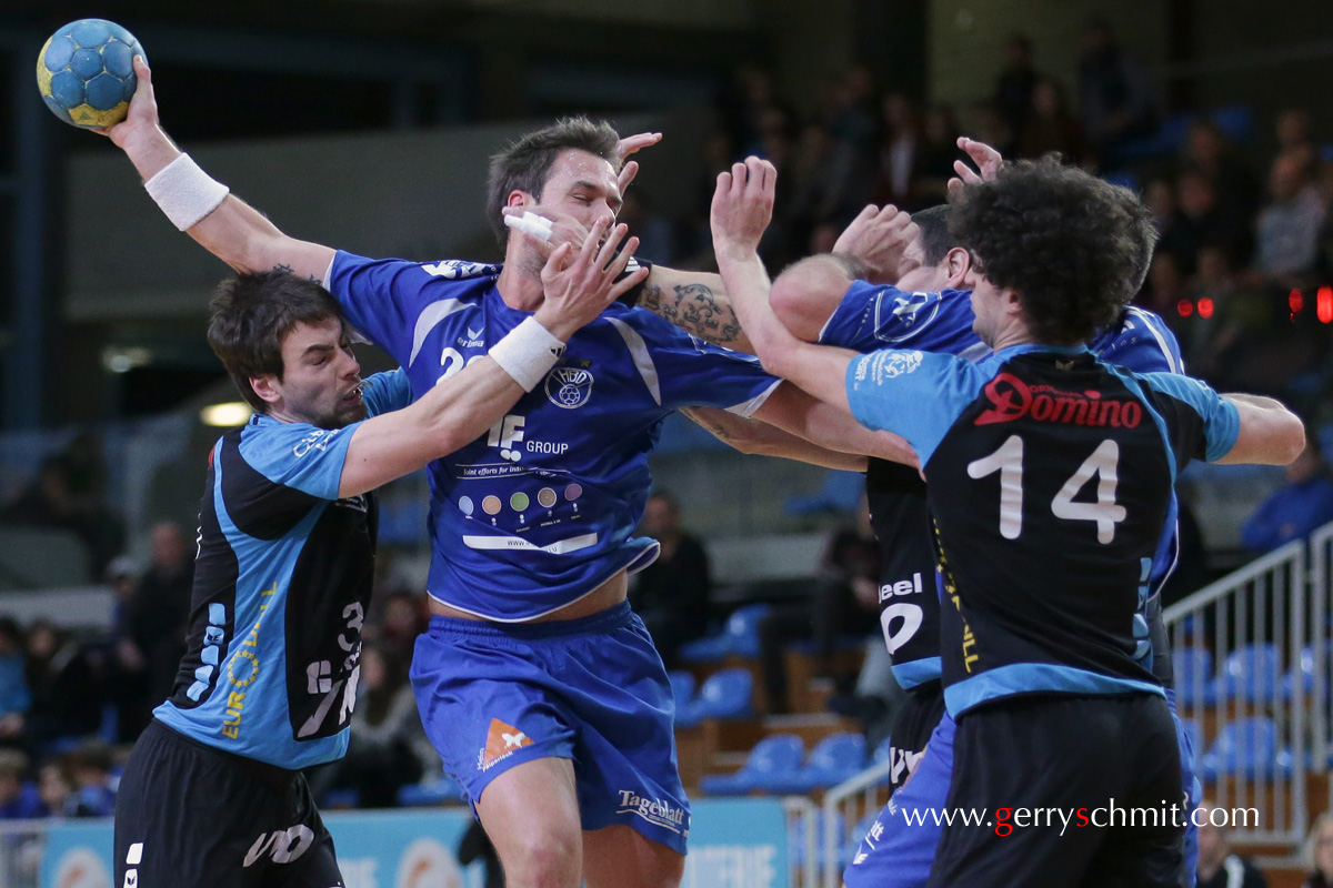 Martin HUMMEL (HB Dudelange) is challenged by 3 players of Tongeren during the EHF Game HBD - Tongeren