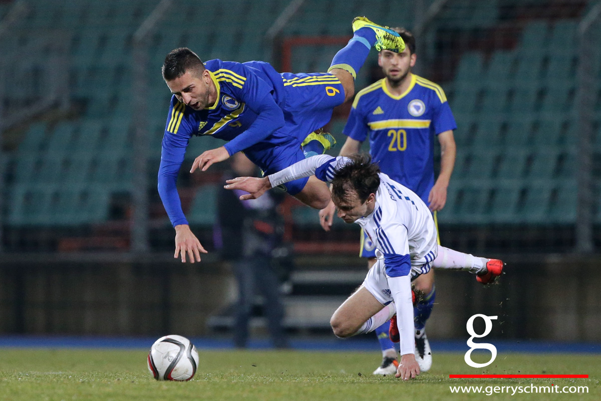 Vedad Ibisevic of Bosnia is challenged by Lars Gerson of Luxembourg during international friendly game