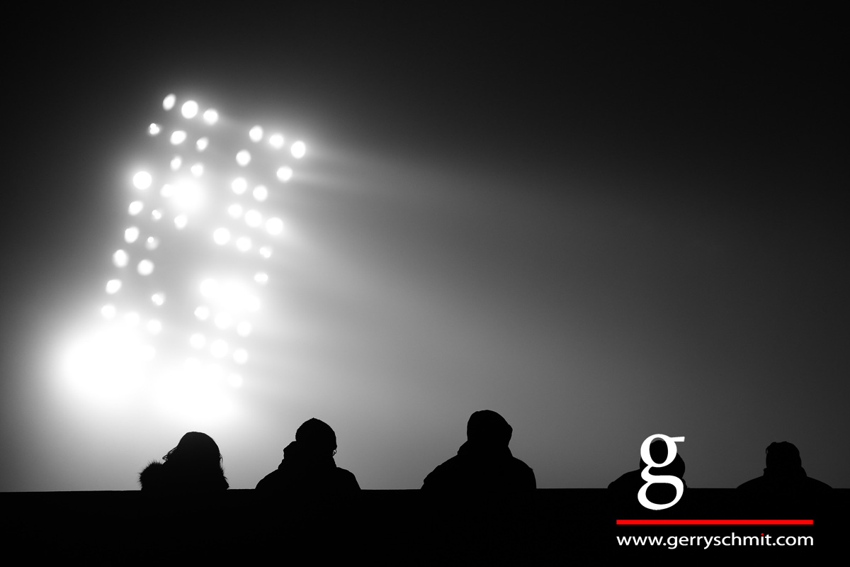 Spectator watch a floodlight football game